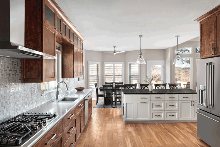 Modern kitchen featuring wood cabinetry and contemporary lighting